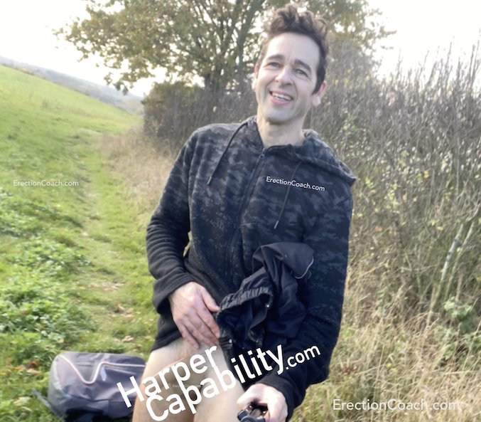 erection coach pulling trousers down in a field to expose penis which is obscured by text